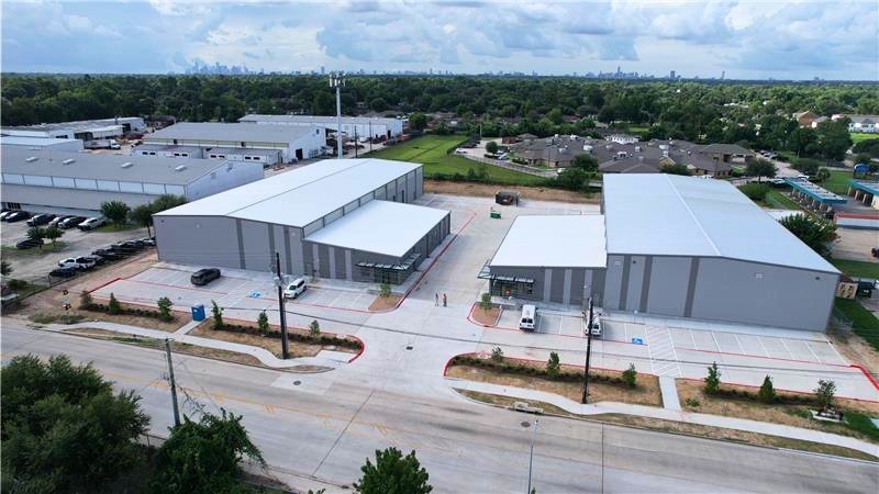 Aerial view of the two completed West Little York manufacturing buildings with the Houston skyline beyond